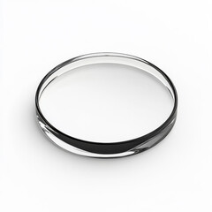 Close up view of a clear lens with a golden edge reflecting light on a white background in a studio setting
