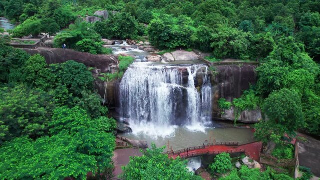 Close-up drone view of Gandahati Waterfall, Gajapati&mdash;crystal-clear water plunges over rocks, embraced by lush forest and scenic serenity.