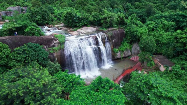 Close-up aerial view of Gandahati Waterfall, Gajapati&mdash;mesmerizing water flow over rugged rocks, wrapped in vibrant green wilderness.