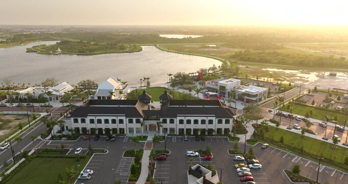 Walkable neighborhood street with recreational infrastructure in North Port, Florida. Wellen Park downtown district at night. Main street square in town center.