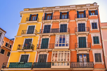 Spanish architecture on a residential building with balconies and shutters in a city