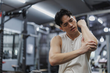 Young athlete experiencing elbow pain in gym