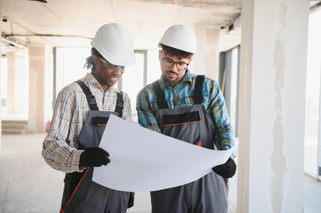 Diverse team collaborating on construction plans