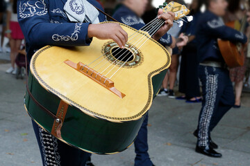 Mexican musician parading and playing a Mexican guitarrón