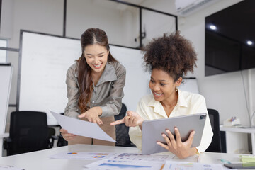 Two business woman working together for analysis data plan business strategies in office, Business discussing and startup concept.