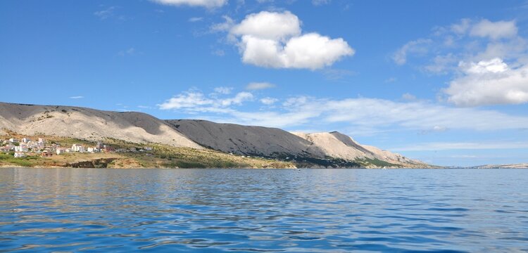 Pag island turquoise sea view, Dalmatia region of Croatia.Stony beach with extra clean sea on Island Pag. Pag s known for being all rocky like moon without much vegetation, because of strong winds