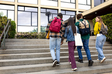 University or college students walking up stairs outside building