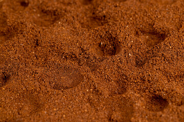 brown ground coffee , uneven ground coffee bean background for making a high-quality and aromatic coffee drink, close up