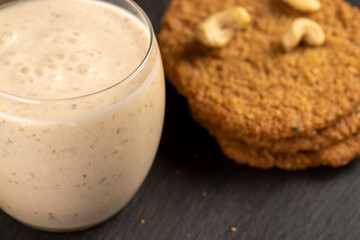cookies and yogurt with prunes, a breakfast of oatmeal cookies and a glass of yogurt, closeup