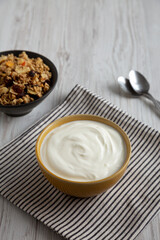 Organic Whole Fat Greek Yogurt in a Bowl, side view. Copy space.