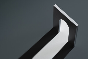 Unique architectural piece casting shadows in a minimalist setting