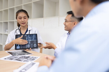 Fototapeta premium Medical team shows and explains MRI having a meeting in conference room at hospital, Medical technology and health care concept.