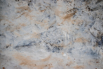 Faded, textured village house wall with peeling paint, an artistic background