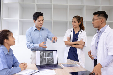 Obraz premium Medical team with laptop computer and examine x ray test results for treatment plans in a modern hospital, Healthcare and medical concept.