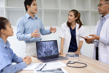 Medical team with laptop computer and examine x ray test results for treatment plans in a modern hospital, Healthcare and medical concept.