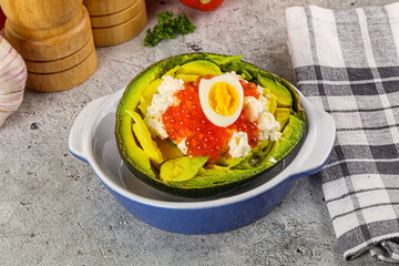 Avocado with red caviar and quil egg
