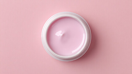 A delicate pink cream or balm in a white oval container on a soft pink background