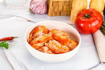 Raw marinated uncooked chicken wings