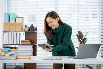 Efficient Accountant: A diligent accountant, immersed in her work, meticulously calculates and...
