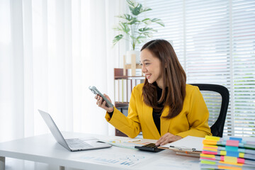 Smart Office Professional: A focused businesswoman, radiates poise as she meticulously reviews...
