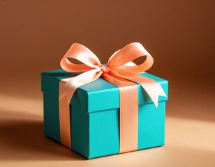 Obraz premium teal gift box with ribbon on peach background.