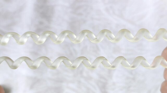 Women's hands stretch a spring-loaded hair band. Hair accessories.