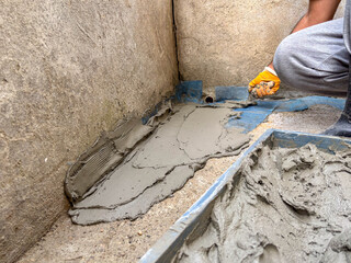 Close-up of a Builder Applying Mortar over a Reinforcement Mesh