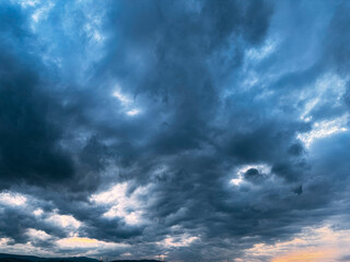 Epic Sky with Dark Storm Clouds and a Break of Light at Sunset