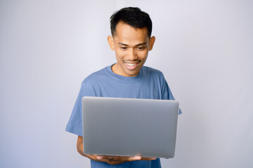 Smiling Person Using A Laptop, Studio Portrait, Gray Backgrounds