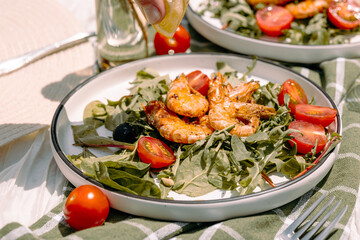 Fresh lemon juice being squeezed over hot grilled prawns — enhancing their smoky, zesty flavor.