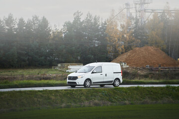 White delivery van on a green country road