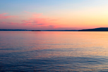 Evening sky-water calm landscape of the large Onega Lake in Karelia.