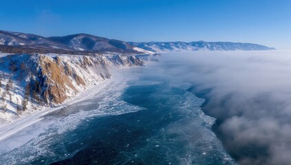 Frozen lake shore with snowy cliffs and mist