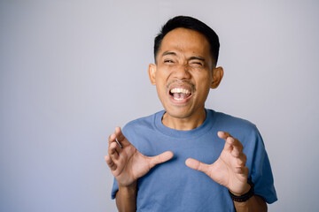 Anxious Adult Male In Blue Shirt Against Light Gray Background