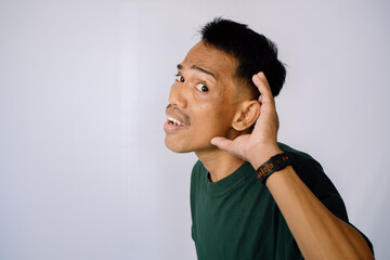 Attentive Person Listening Closely In Profile, Dark Green Shirt, Simple Background