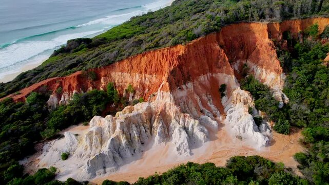 Close-up drone shot of the striking white and orange cliffs of The Pinnacle in Beowa National Park, NSW. Detailed,