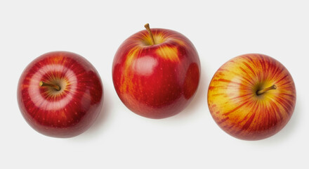 Three red apples are arranged on a white surface.