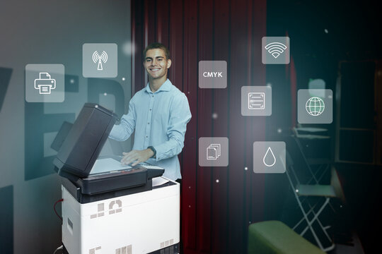Young man using a multifunction printer in an office environment, showcasing modern technology and digital integration - Powered by Adobe
