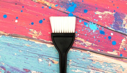 Paint brush on colorful wood background