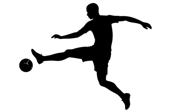 Silhouette of a soccer player kicking a ball in mid air