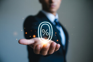 Businessman holding a glowing percentage symbol in his hand with digital effects