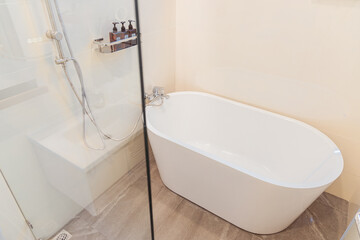Modern ryokan bathroom designed in japanese style with sleek white bathtub and shower area offering perfect place to rest and relax after long day