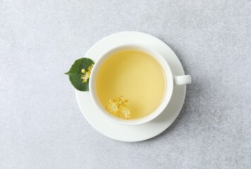Close-up of green tea with fragrant linden in white cup