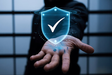 Man holding a glowing digital shield with a checkmark symbolizing security and protection