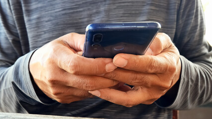 Smartphone in Hand: A close-up shot of a person holding a smartphone, highlighting modern communication.