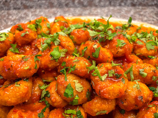 A Platter of Traditional Turkish Fellah Köftesi with a Rich Tomato and Herb Sauce