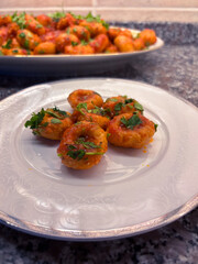 A Plate of Homemade Fellah Köftesi with a Serving Platter Blurred in the Background