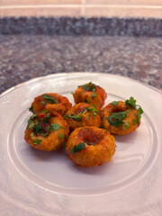 Close-Up of a Serving of Turkish Bulgur Meatballs with Parsley on a White Plate