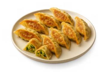 Crispy fried gyoza dumplings, filled with fresh vegetables, served on a plate with transparent background