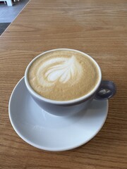 A cup of cappuccino on a table in a cafe